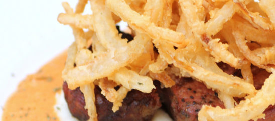 Filet Mignon with Roasted Red Pepper Cream Sauce, Mash Potatoes, and Onion Strings